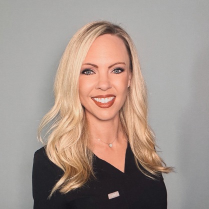 Alissa Springer, smiling woman in a black blouse