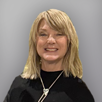 Pam Smith, smiling woman in a gray blouse and silver bolo tie